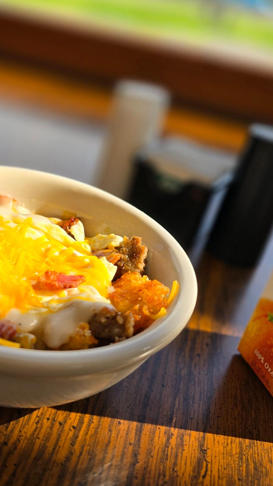 Delicious cheesy potato bowl with toppings.