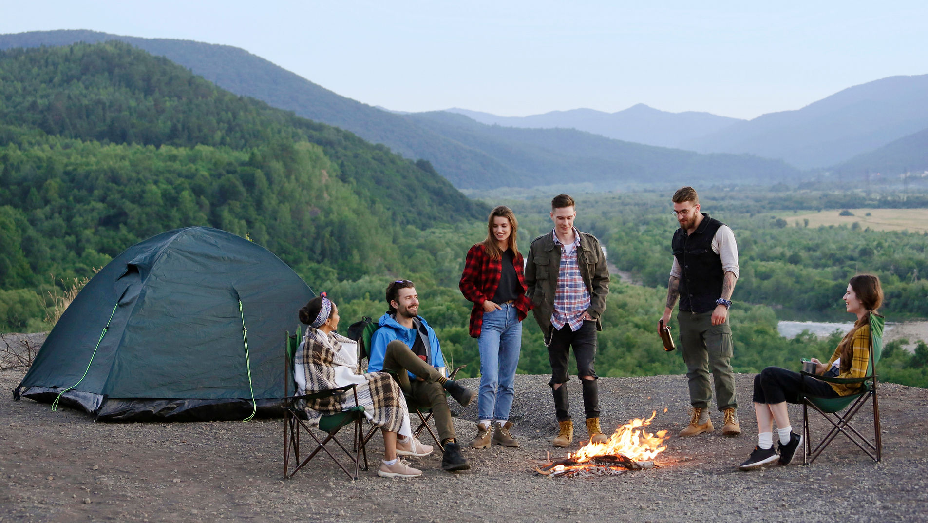 Group camping by a fire

